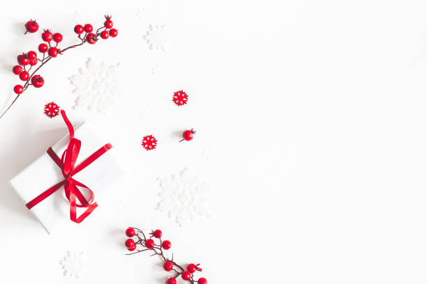 istock Christmas composition. Frame made of gift, snowflakes, red berries on white background. Christmas, winter, new year concept. Flat lay, top view, copy space 1080168142