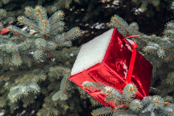 istock Christmas tree in the street decorated with red balls and giftboxes 1080181206