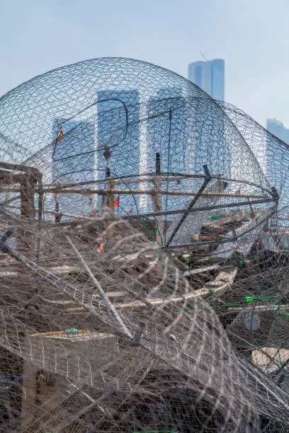 Photo of View on Abu Dhabi from the fishing harbour with nets on the foreground