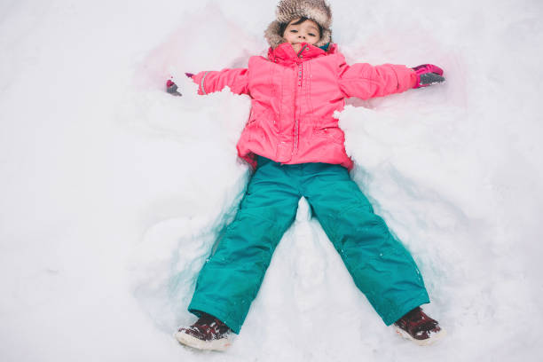 istock happy baby lying in the snow. Winter and cold. 1080185574