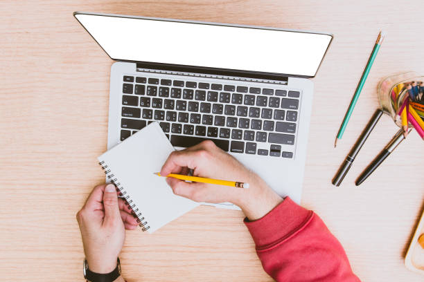 istock Hand of student holding a pen writing note message on paperwork .Top view 1080189036
