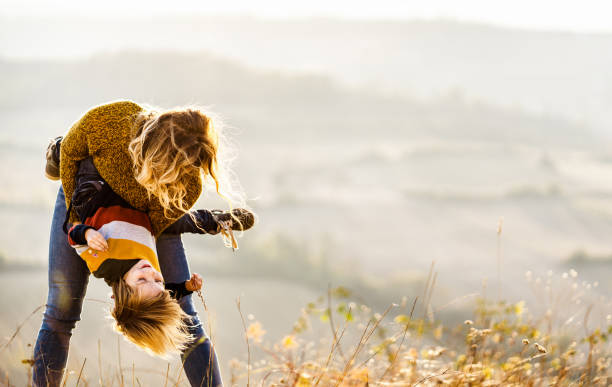 istock Playful mother having fun with her small boy on the field. 1080189164