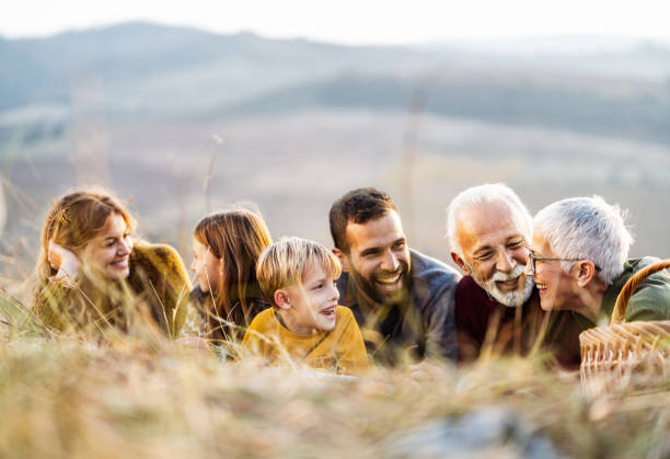 istock Happy multi-generation family communicating during autumn day on the field. 1080189672