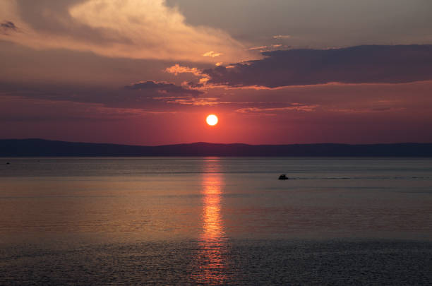 istock Sunset above sea wtih clouds and red heaven. 1080198552