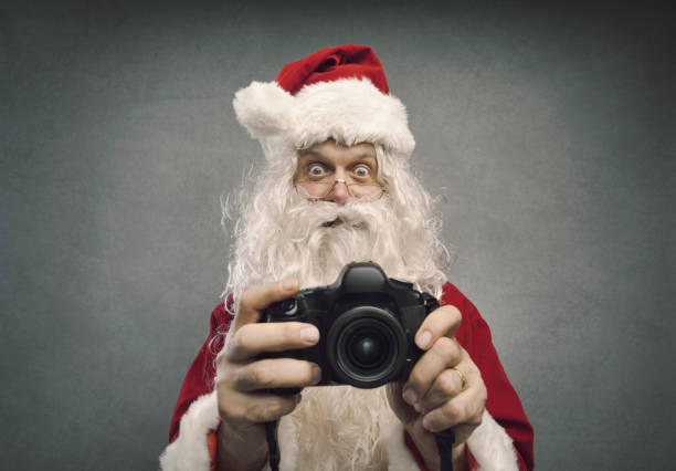 istock Santa Claus taking holiday pictures 1080199114