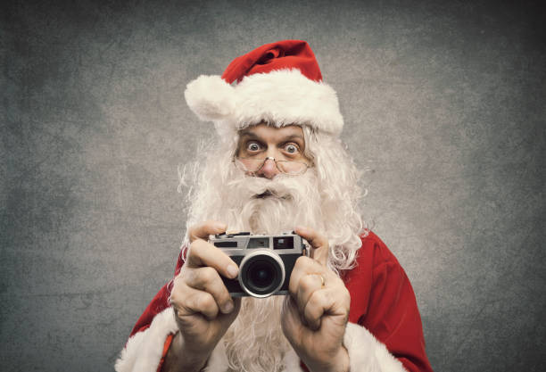 istock Santa Claus taking holiday pictures 1080199186
