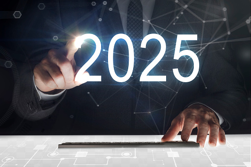Business man touching screen with 2025 writing