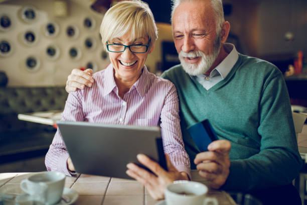 istock Two senior people shopping online using digital tablet 1080207114