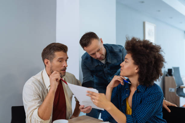 istock Multi-ethnic business people brainstorming in office together 1080207604