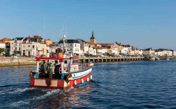 Fishing trawler returning to harbor with the dock of la Chaume in the background (Les Sables d'Olonne, France)