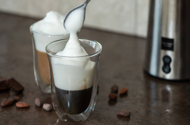 istock Milk foam is put in a coffee. 1080214256