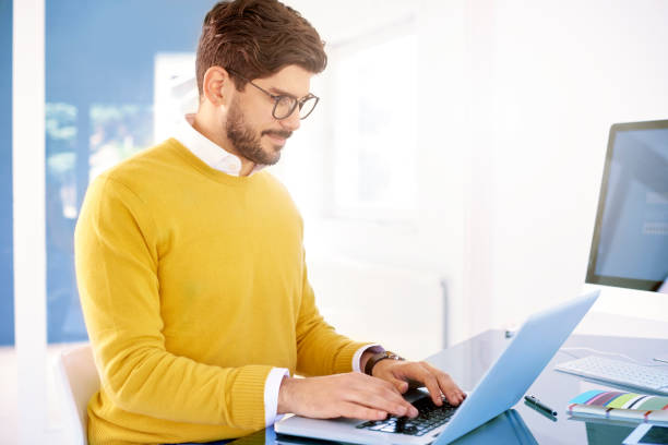 istock Confident casual businessman using his notebook in the office 1080218714