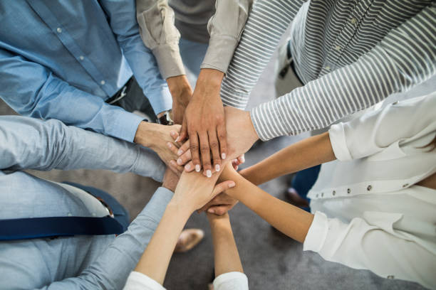 istock Above view of business team gathering their hands in unity. 1080218970
