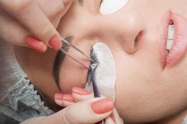 istock Lashmaker. Woman's lashes extension. special cosmetic face stickers. 1080222400