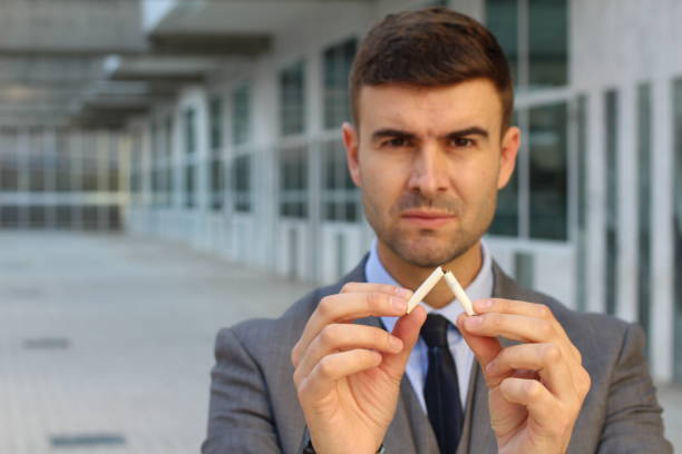 istock Serious businessman breaking a cigarette 1080224020