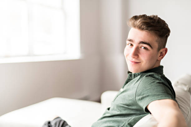 istock Handsome confident young man relaxing at home on the sofa 1080229064