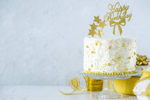 istock Golden birthday concept - cake, presents, decorations 1080232906