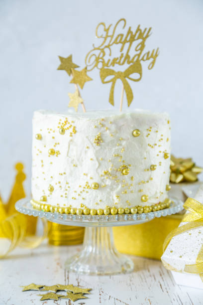 istock Golden birthday concept - cake, presents, decorations 1080232944