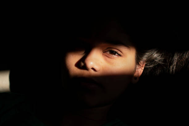 istock Sunlight shadow on girl face 1080236074