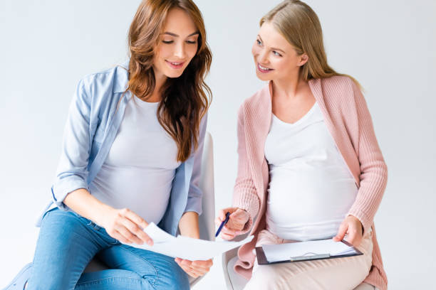 istock pregnant women talking at prenatal class isolated on white 1080236756