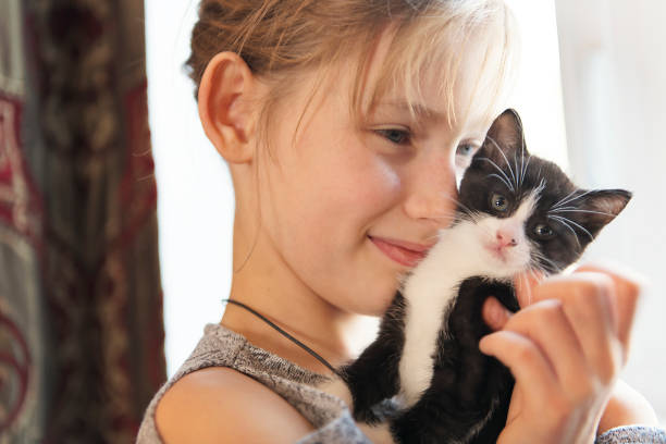 istock 10 years old girl with kitten at home 1080240064