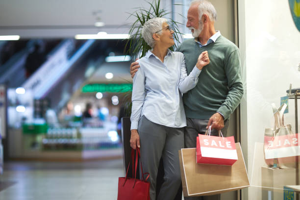 istock Senior elder couple lovingly looking at each other while window shopping together 1080241974