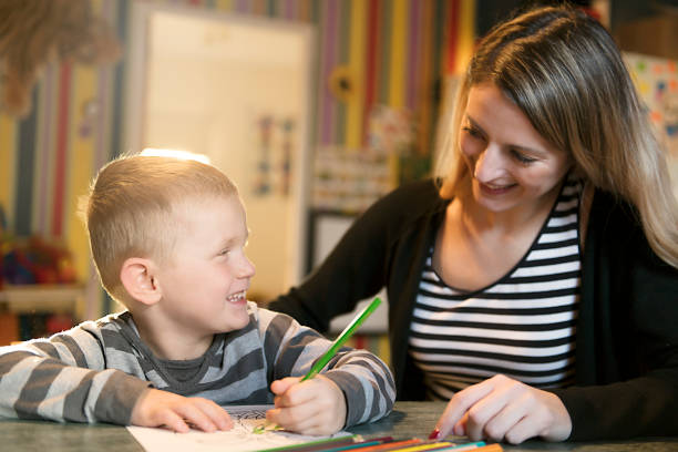istock Cute little boy drawing at kindergarten. Creative kid at playschool 1080247128