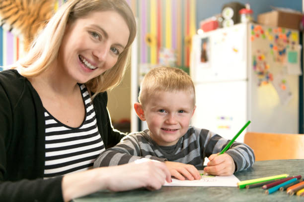 istock Cute little boy drawing at kindergarten. Creative kid at playschool 1080247228