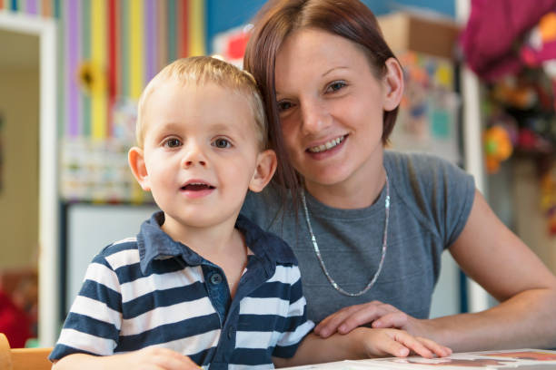 istock Cute little boy drawing at kindergarten. Creative kid at playschool 1080247608