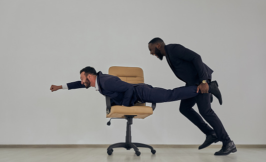 The businessmen playing with chair