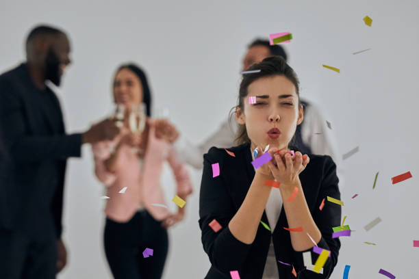 istock The attractive woman blowing confetti 1080254324