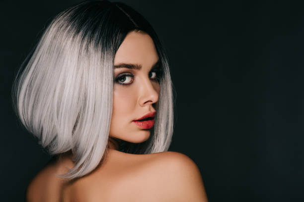 attractive girl posing in grey wig, isolated on black