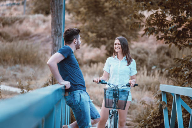 istock Young Cheerful Couple Flirting On a Park Bridge 1080257446
