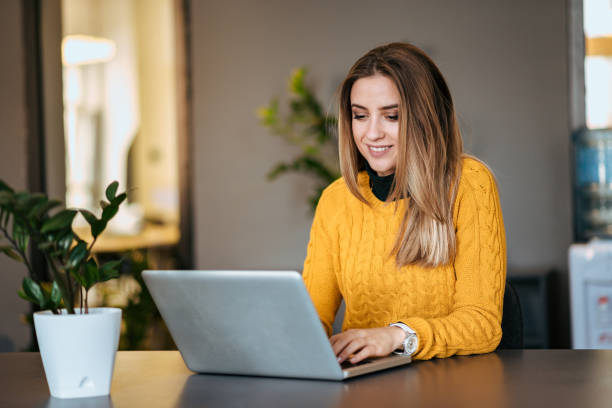 istock Beautiful young woman using laptop indoors. 1080258932