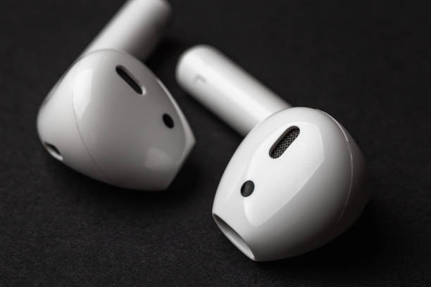 istock White wireless bluetooth earphones or headphones, close up 1080261986