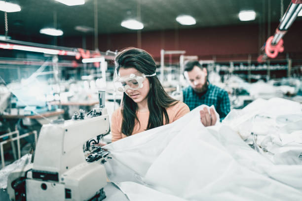 The studio cuts fabrics and sews clothes of different shapes and colors