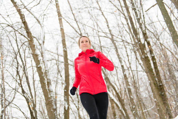 istock Blond woman running outdoors on a cold winter day 1080269554