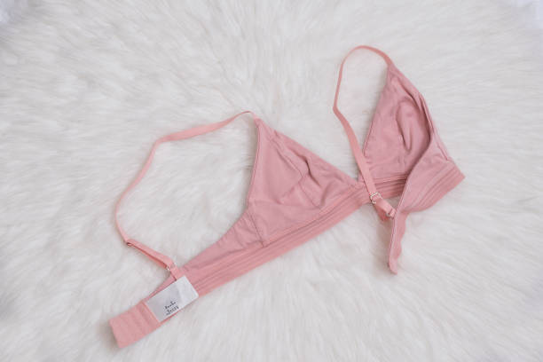 istock Pink bra on white fur. Inner side. Fashion concept 1080273252