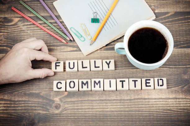 istock Fully committed. Wooden letters on the office desk 1080274180