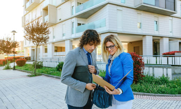 Businesspeople checking documents in the street