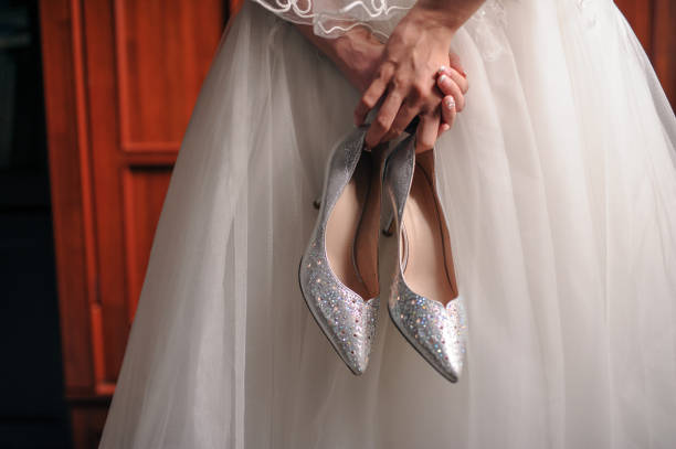 Brides holding a pair of wedding shoe