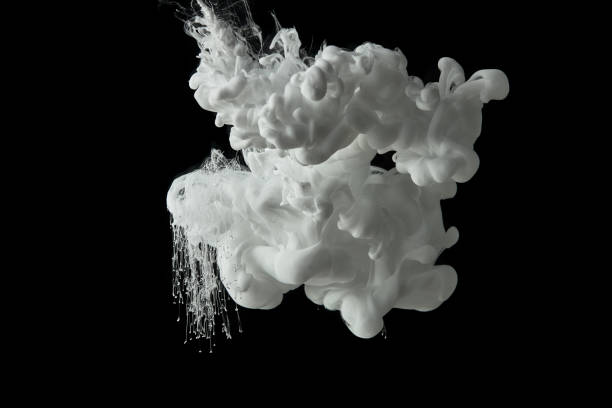 istock white paint swirls in water on black background 1080286014