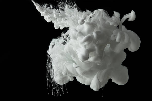 istock white paint flowing in water on black background 1080286044