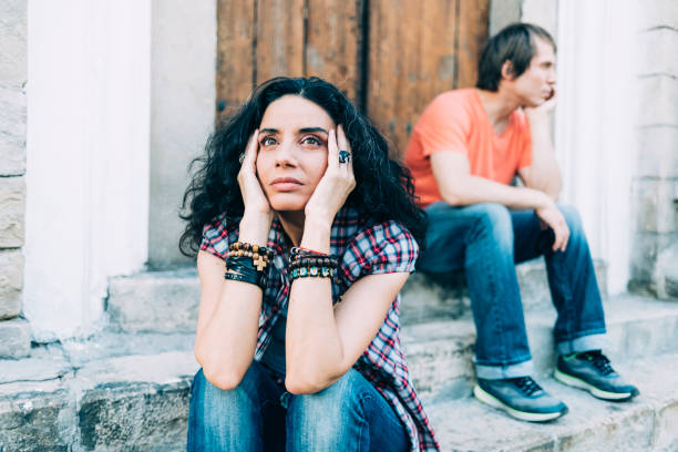 istock Young couple sitting on street 1080288772