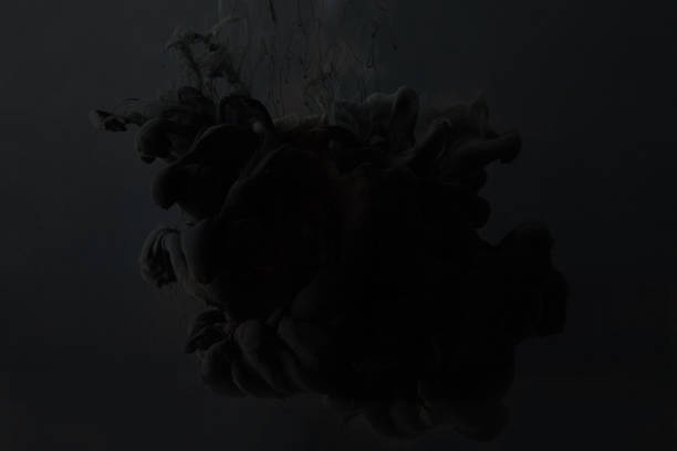 black gouache paint splash on dark background