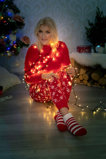 istock Attractive blond woman wrapped in christmas lights 1080290112