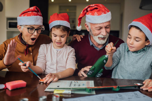 istock Old couple helping children assemble a toy 1080291798