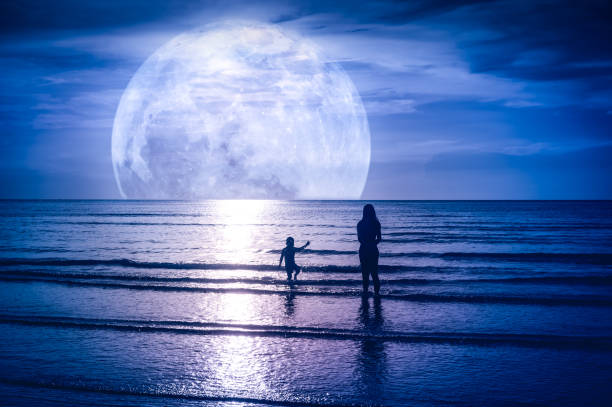 istock Super moon. Colorful sky with cloud and bright full moon over seascape. 1080292464