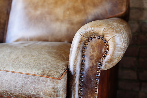 Closeup texture of vintage brown leather sofa in room