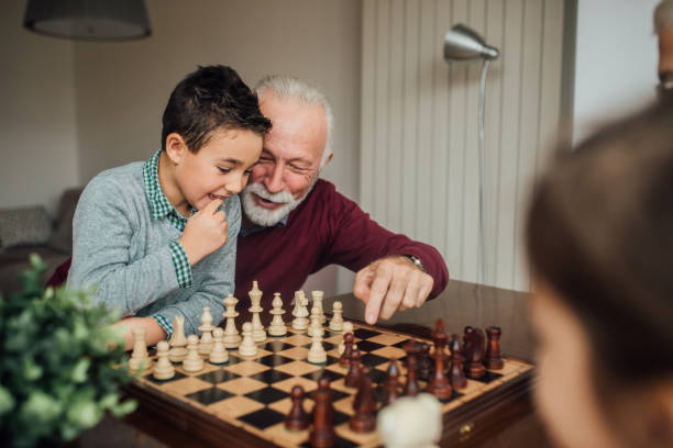 istock Man teaching child to play chess 1080295276